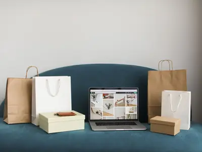 Laptop surrounded by shopping bags and parcels